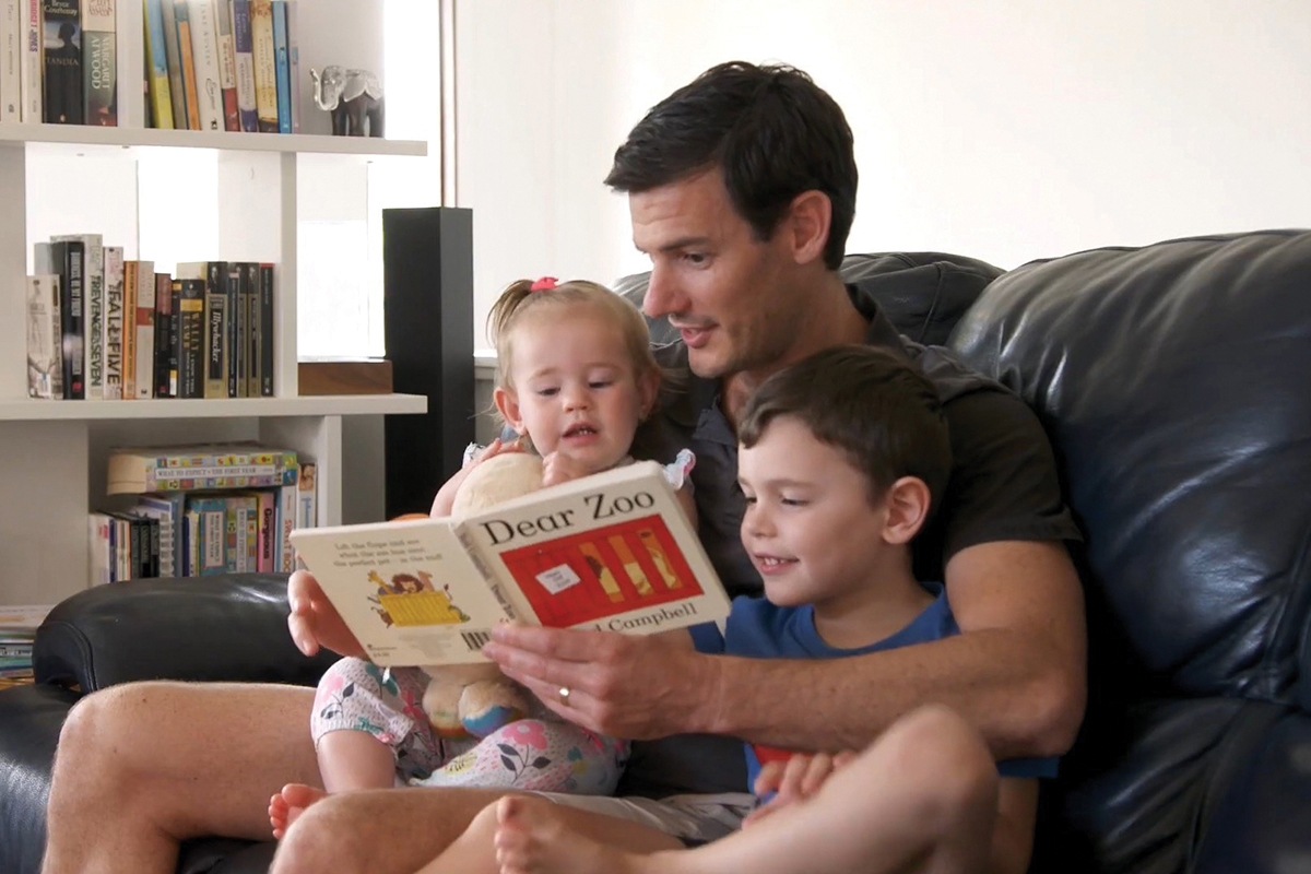 Father reading to his children