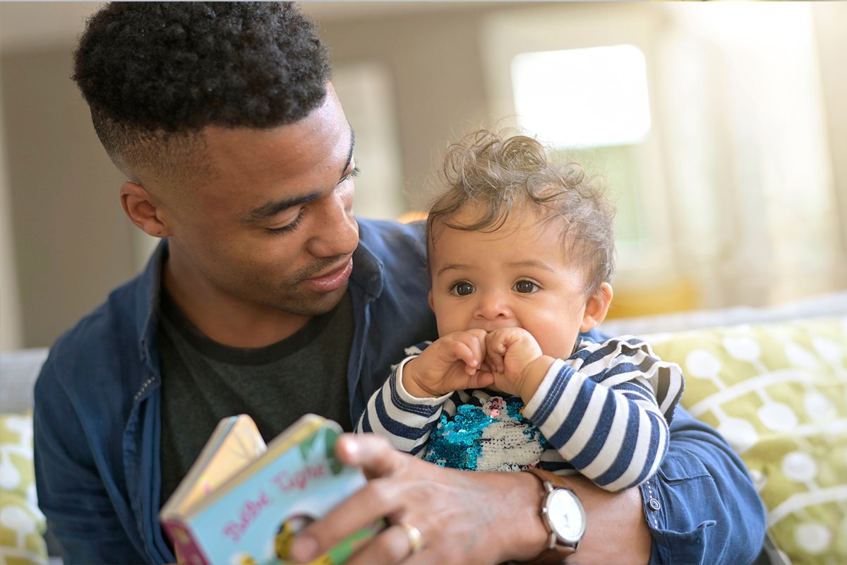 Dad reading to his baby